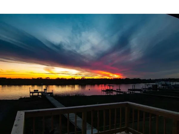 a view of a swimming pool with a lake from a balcony