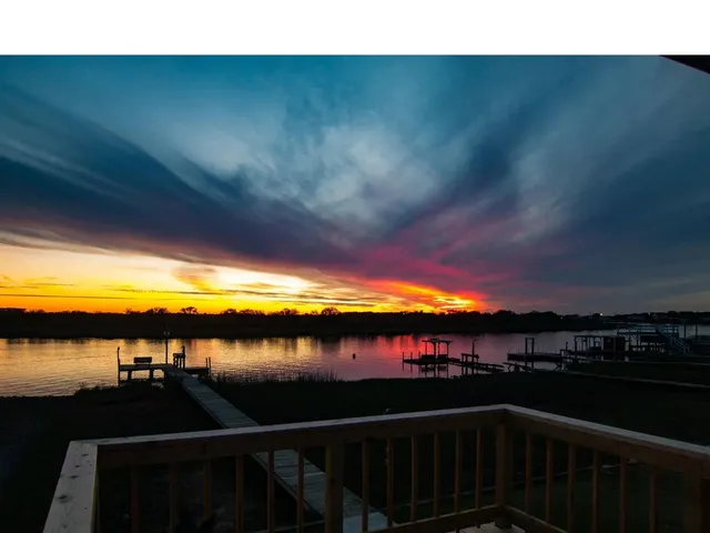 a view of a swimming pool with a lake from a balcony