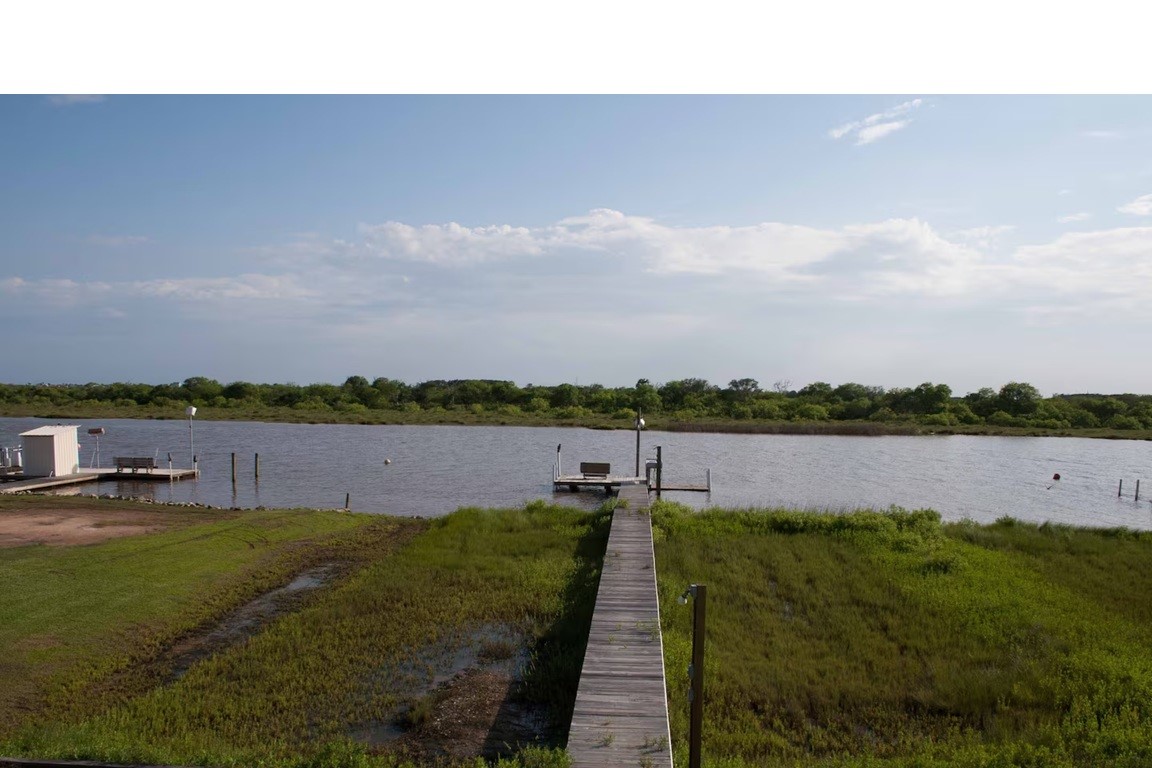 460 616th Sargent, TX 77414 - Photo 18 of 23 a view of a lake with a city