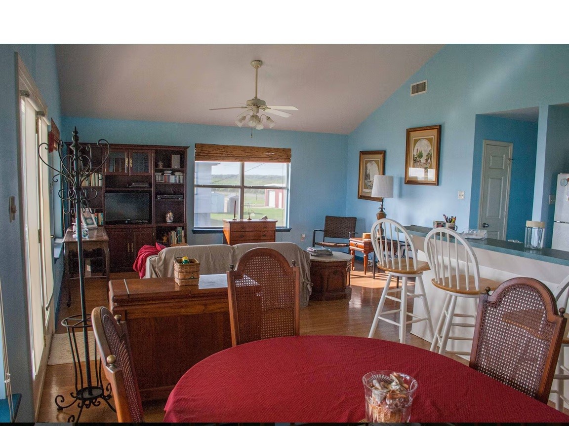 460 616th Sargent, TX 77414 - Photo 5 of 23 a living room with furniture a chandelier and a flat screen tv