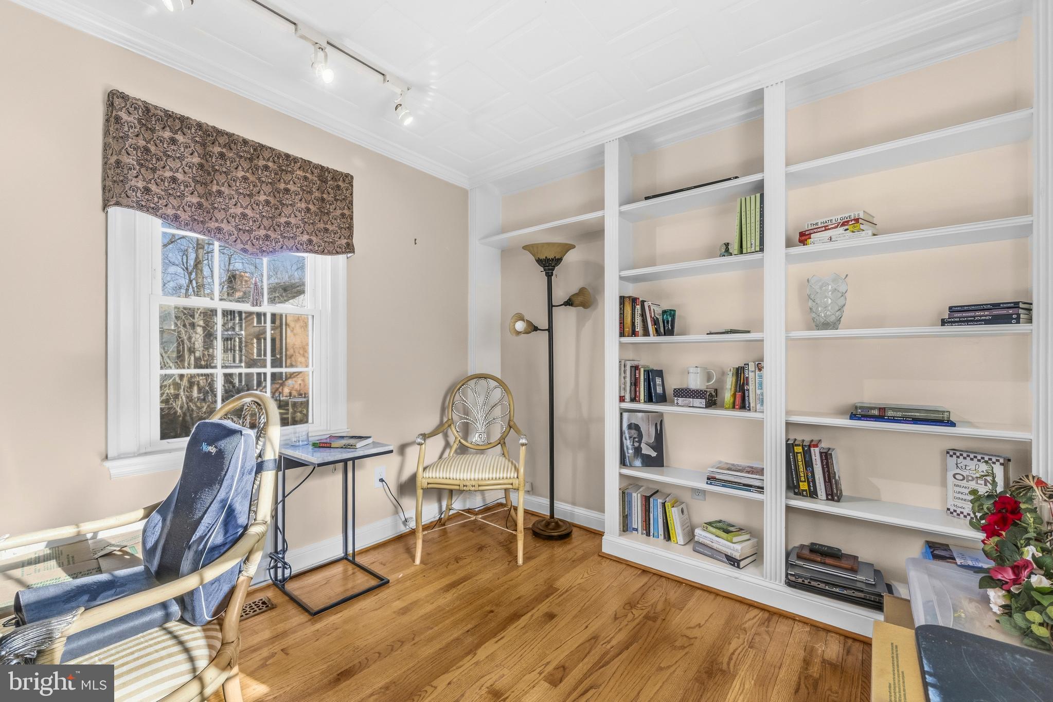 11806 Bishops Content Road Bowie, MD 20721 - Photo 14 of 49 a living room with furniture a rug and a book shelf