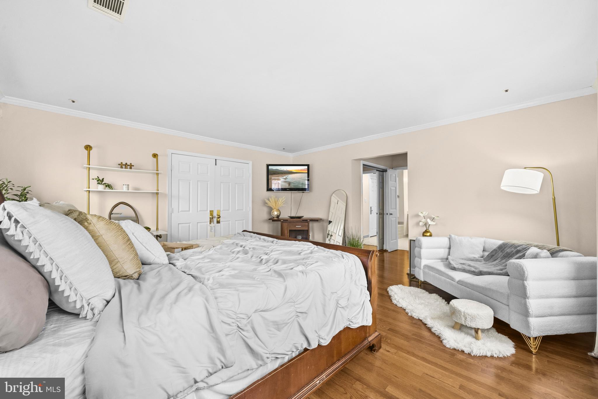 11806 Bishops Content Road Bowie, MD 20721 - Photo 17 of 49 a spacious bedroom with a bed and wooden floor