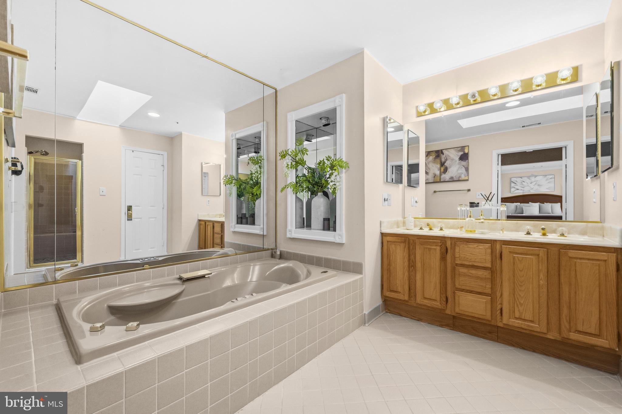 11806 Bishops Content Road Bowie, MD 20721 - Photo 24 of 49 a spacious bathroom with a tub sink and mirror