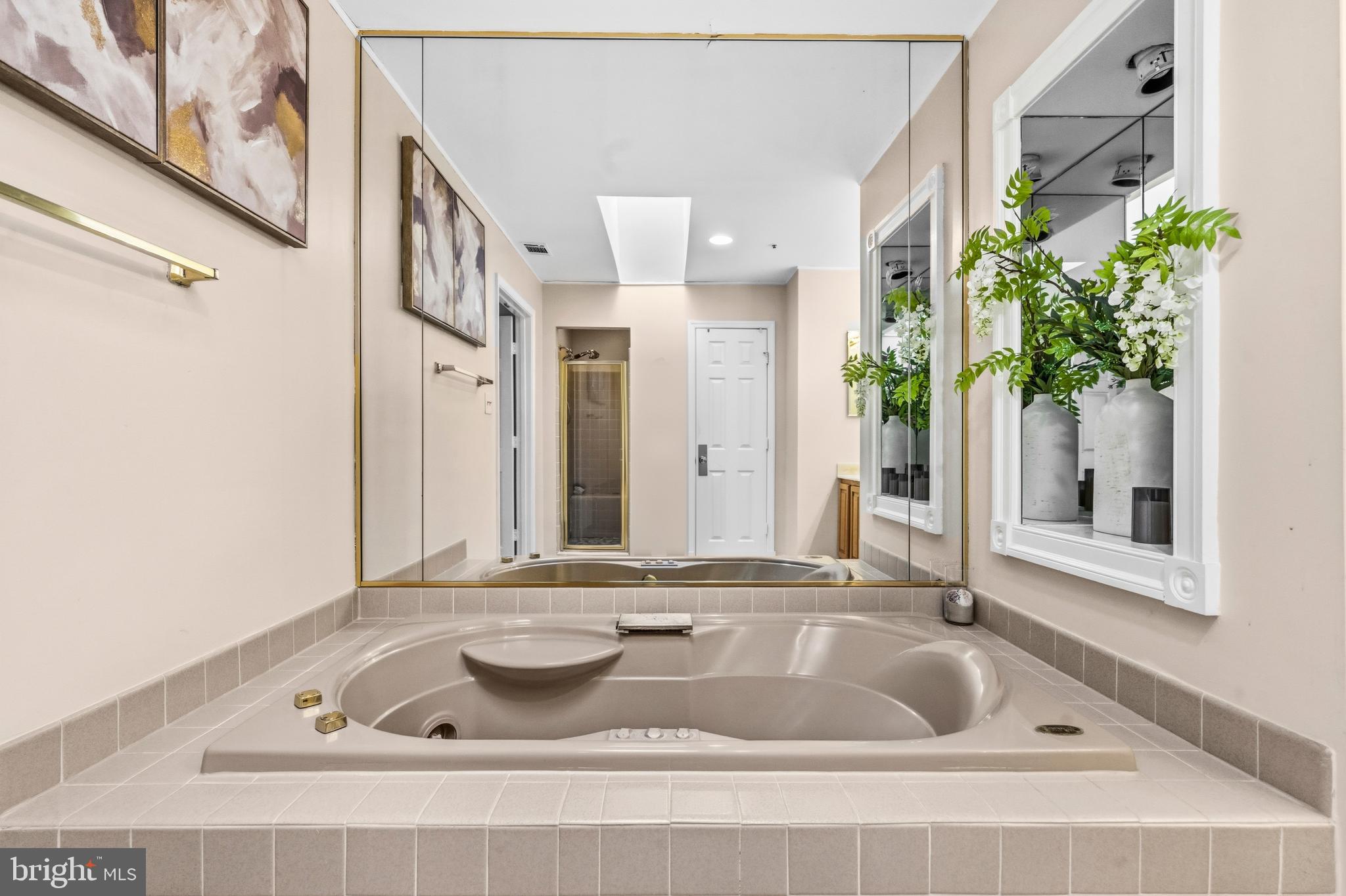 11806 Bishops Content Road Bowie, MD 20721 - Photo 25 of 49 a bathroom with a tub sink and mirror