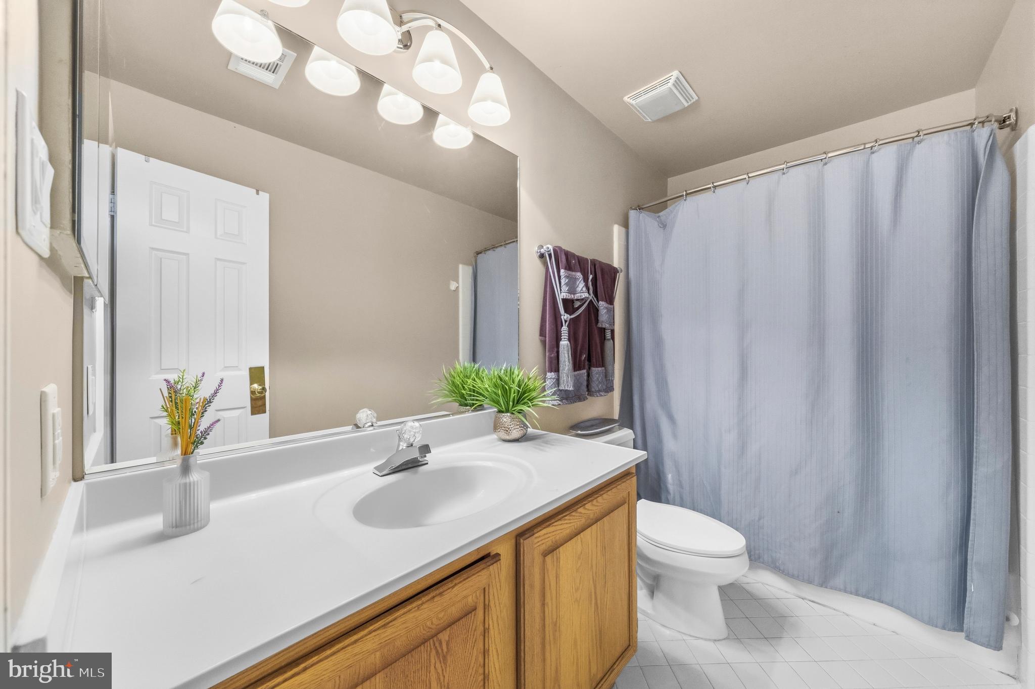 11806 Bishops Content Road Bowie, MD 20721 - Photo 28 of 49 a bathroom with a sink vanity mirror and toilet