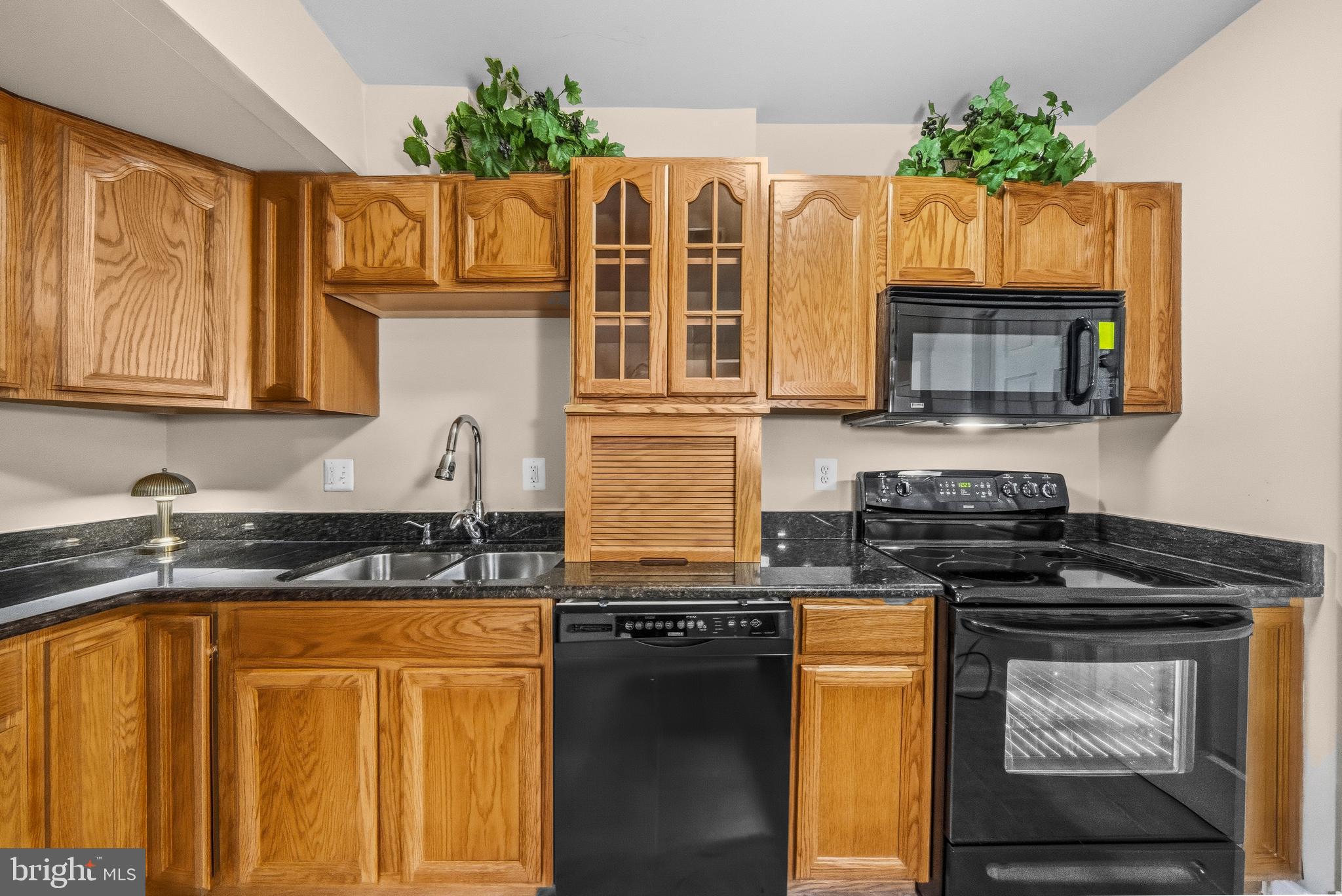 11806 Bishops Content Road Bowie, MD 20721 - Photo 33 of 49 a kitchen with granite countertop stainless steel appliances a stove a sink a microwave and cabinets