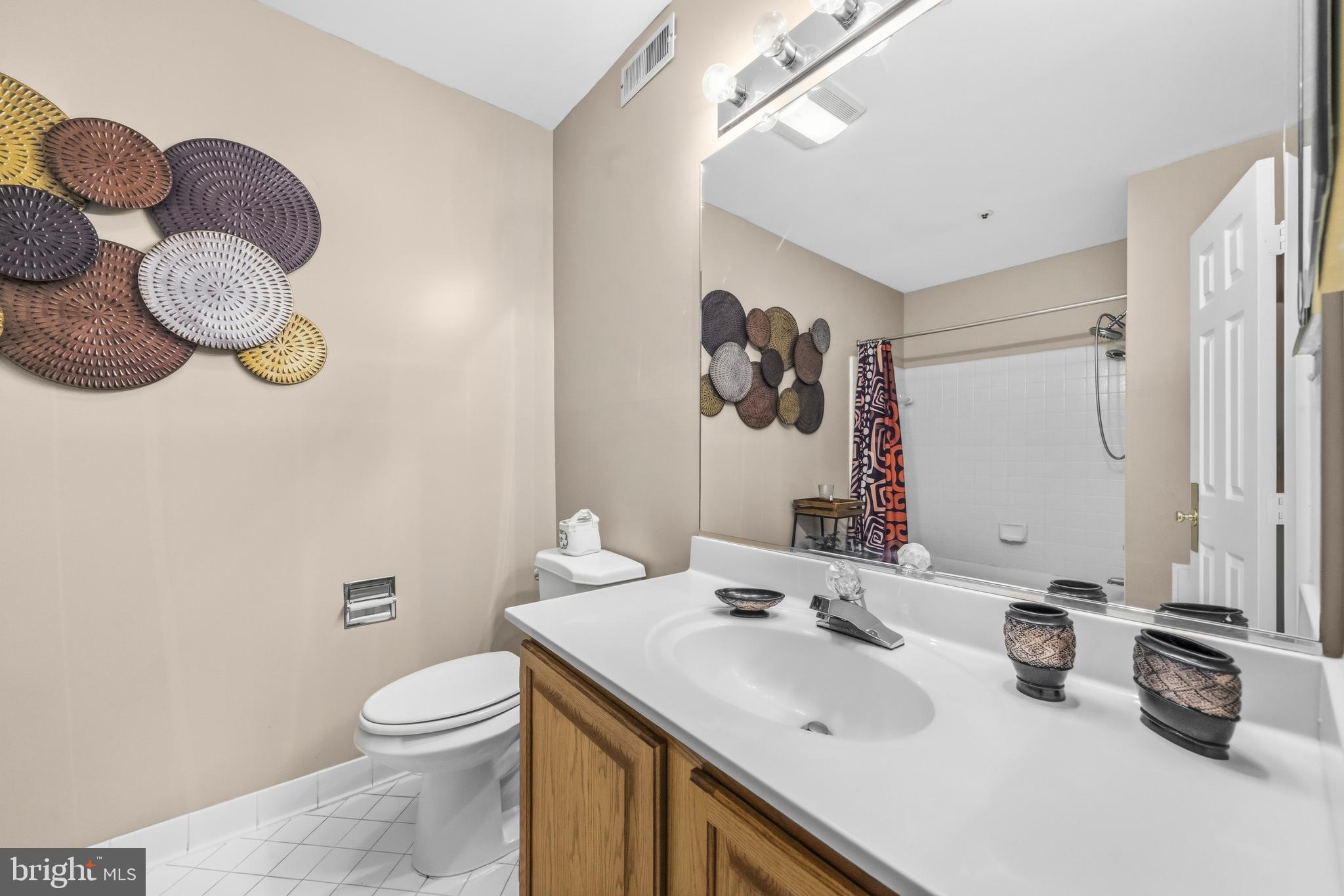 11806 Bishops Content Road Bowie, MD 20721 - Photo 35 of 49 a bathroom with a sink mirror and toilet