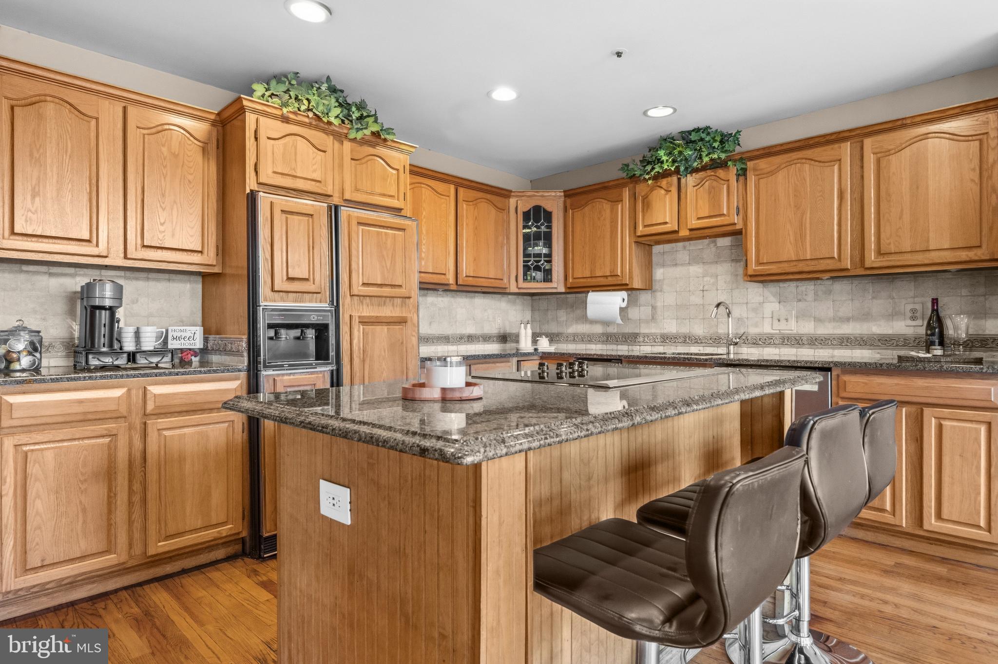 11806 Bishops Content Road Bowie, MD 20721 - Photo 5 of 49 a kitchen with stainless steel appliances granite countertop a stove a sink a microwave and a refrigerator