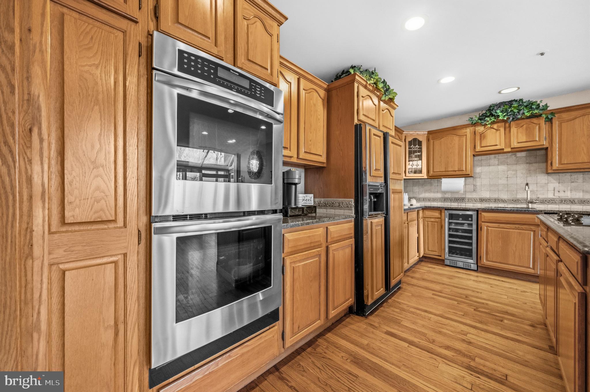 11806 Bishops Content Road Bowie, MD 20721 - Photo 7 of 49 a kitchen with stainless steel appliances granite countertop a stove and a refrigerator