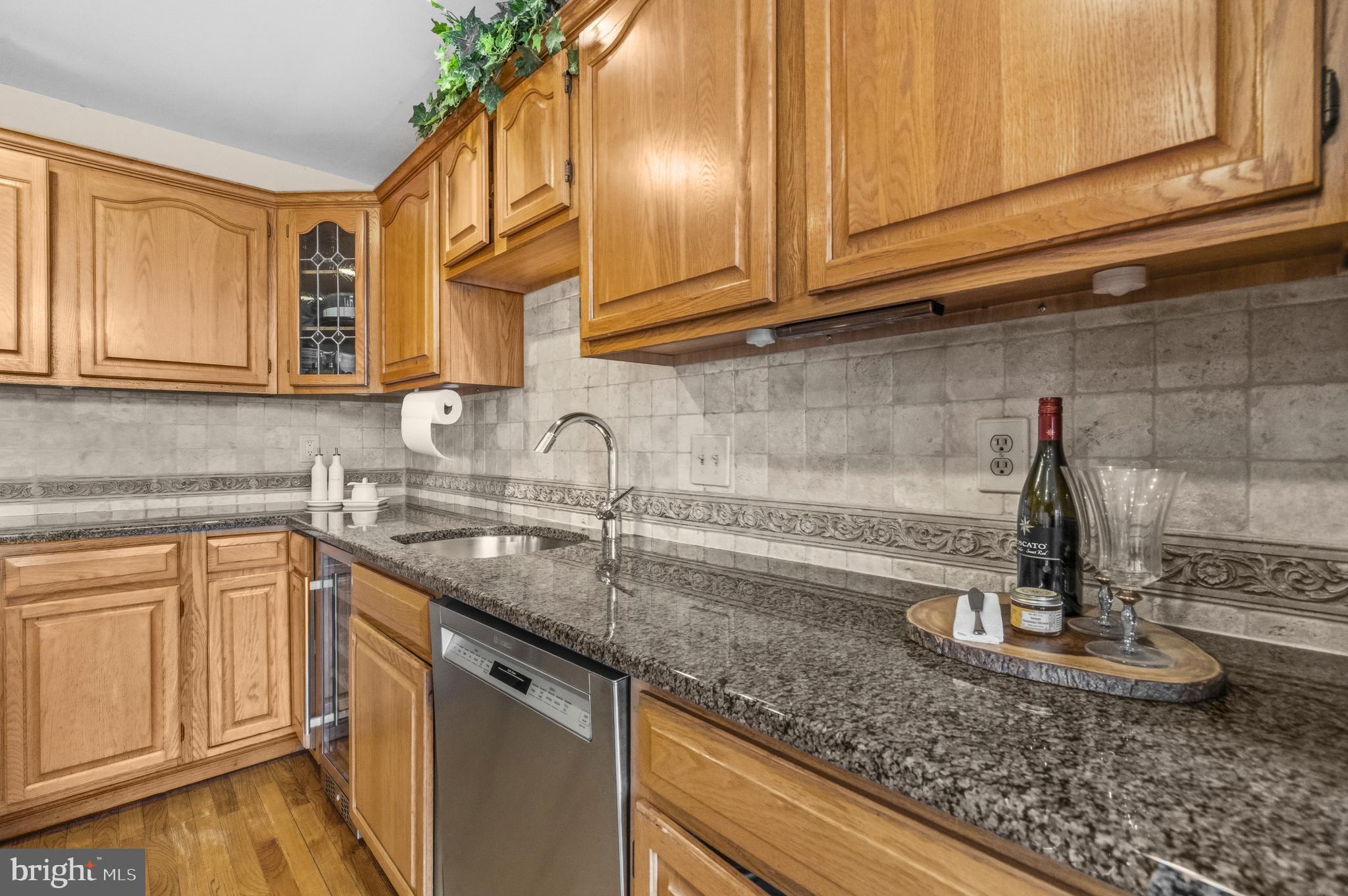 11806 Bishops Content Road Bowie, MD 20721 - Photo 8 of 49 a kitchen with granite countertop a sink stainless steel appliances and cabinets