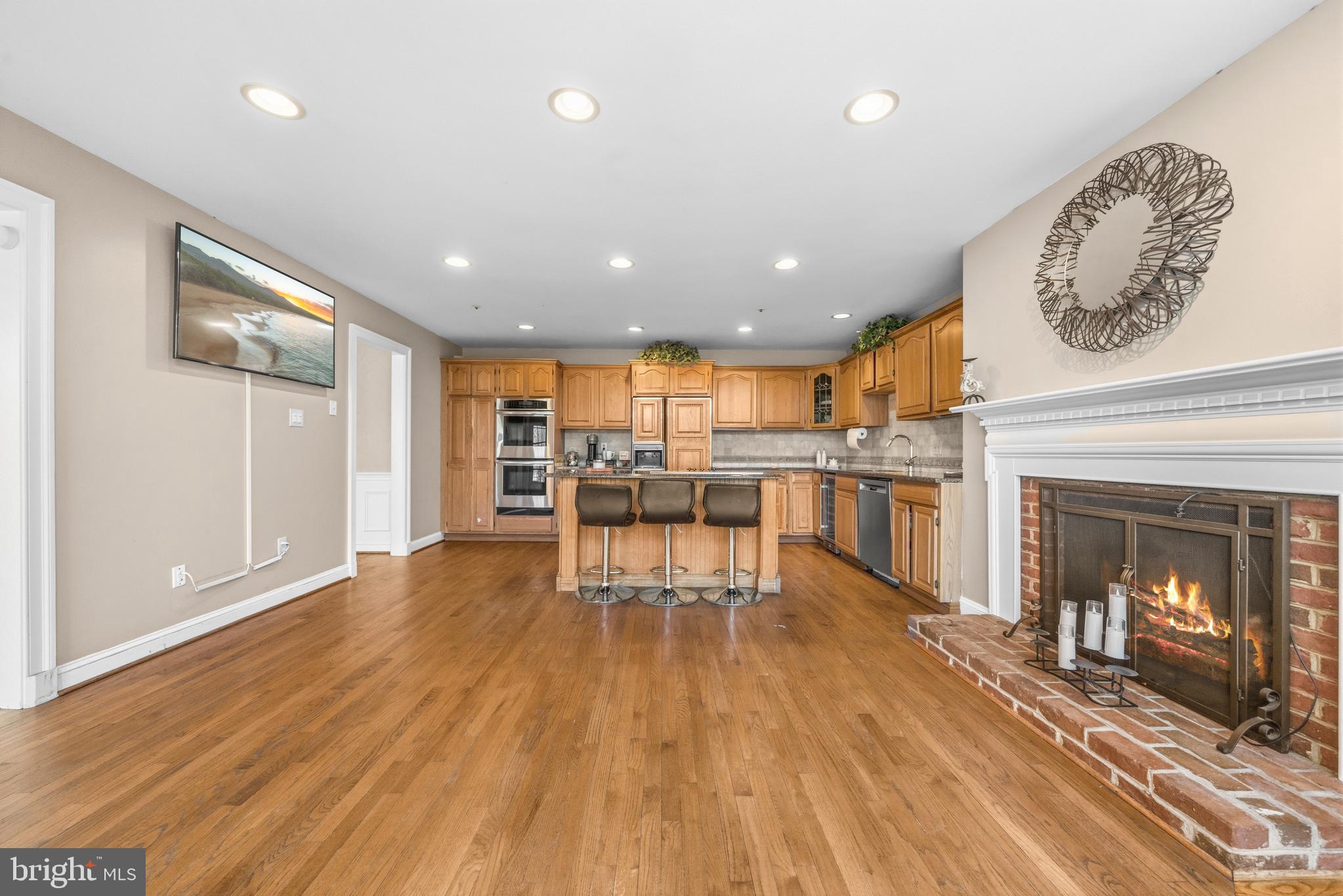 11806 Bishops Content Road Bowie, MD 20721 - Photo 10 of 49 an open kitchen with a table and chairs