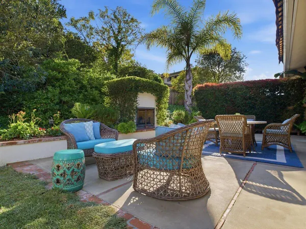 a view of backyard with outdoor seating and plants