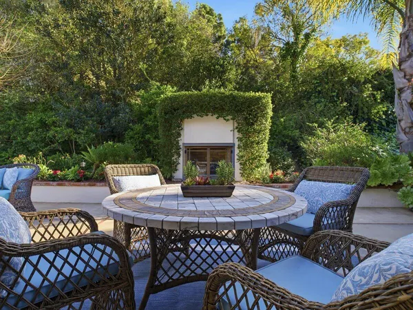 a view of a patio with table and chairs with wooden floor and fence
