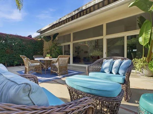 a view of a patio with couches chairs dining table and chairs