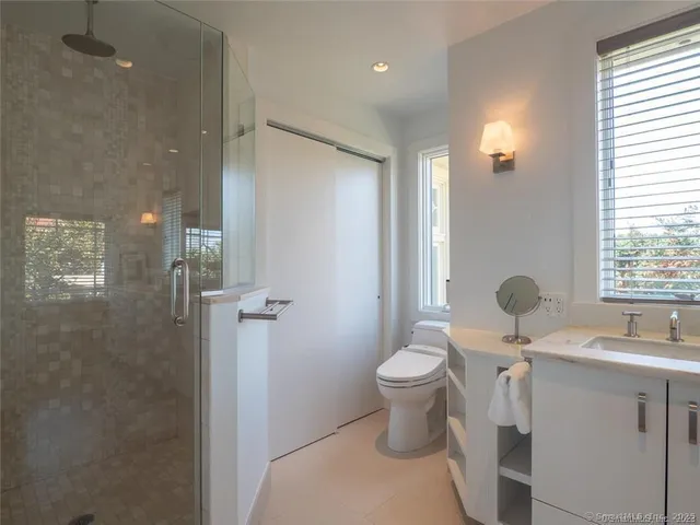 a view of a brick house with a yard and potted plants