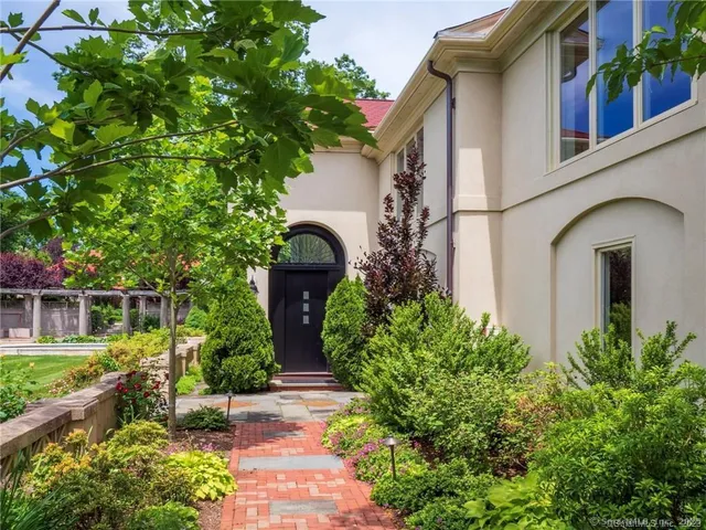 a front view of a house with garden