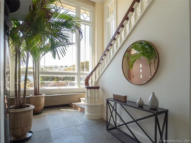 a living room with furniture fireplace and a large window