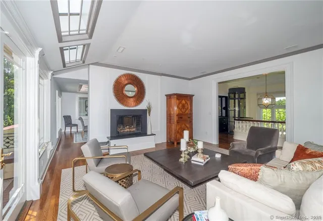 a living room with furniture wooden floor and a chandelier