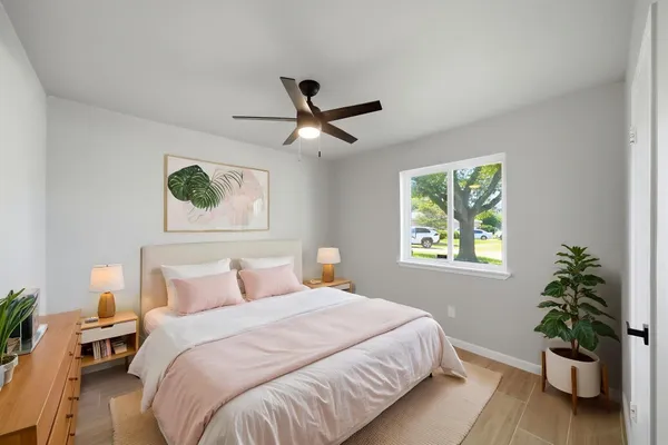 a bedroom with a bed and a potted plant