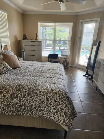 a bedroom with a bed and large windows