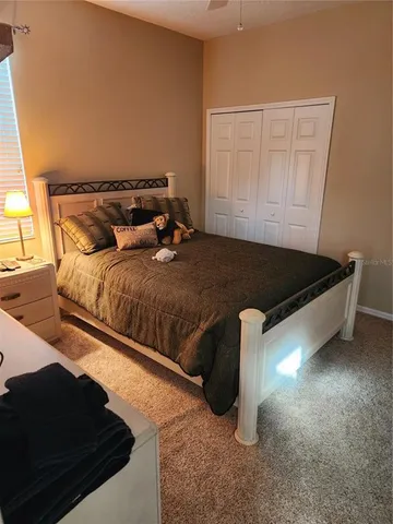 a bedroom with a bed and a cabinet