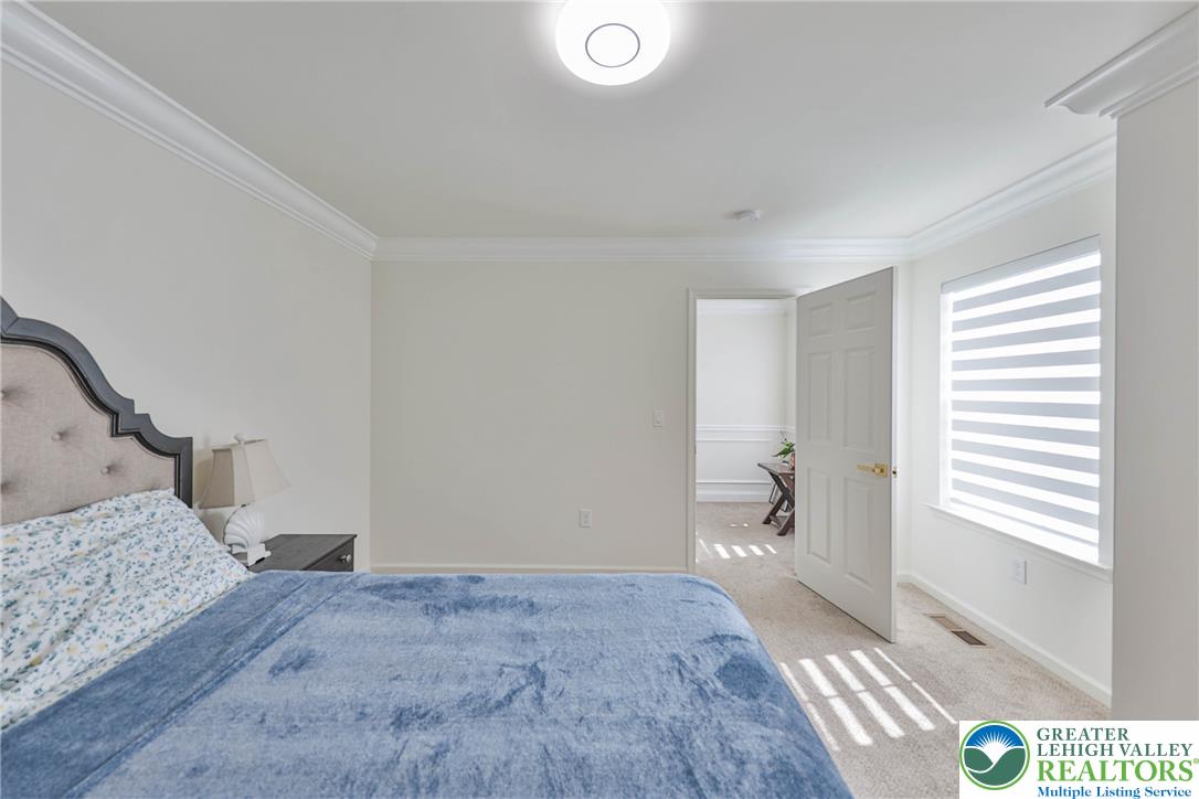 1105 Meco Road Easton, PA 18040 - Photo 69 of 100 Crisp crown molding and plush carpeting define this serene bedroom space.