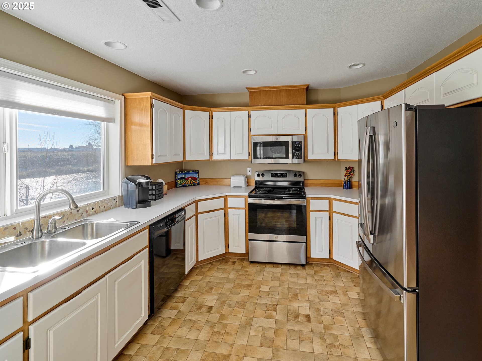 920 Hermanson Street Woodburn, OR 97071 - Photo 12 of 48 a kitchen with a refrigerator sink and cabinets