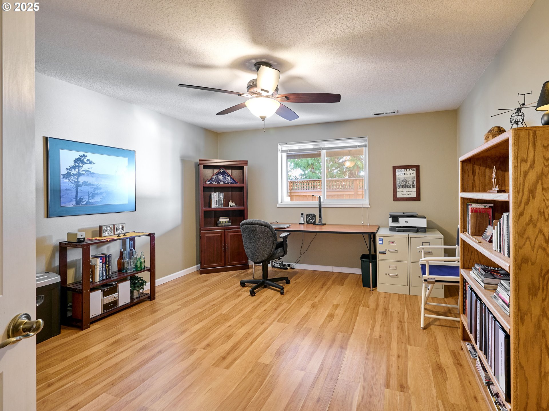 920 Hermanson Street Woodburn, OR 97071 - Photo 23 of 48 a view of a workspace with furniture and a bookshelf