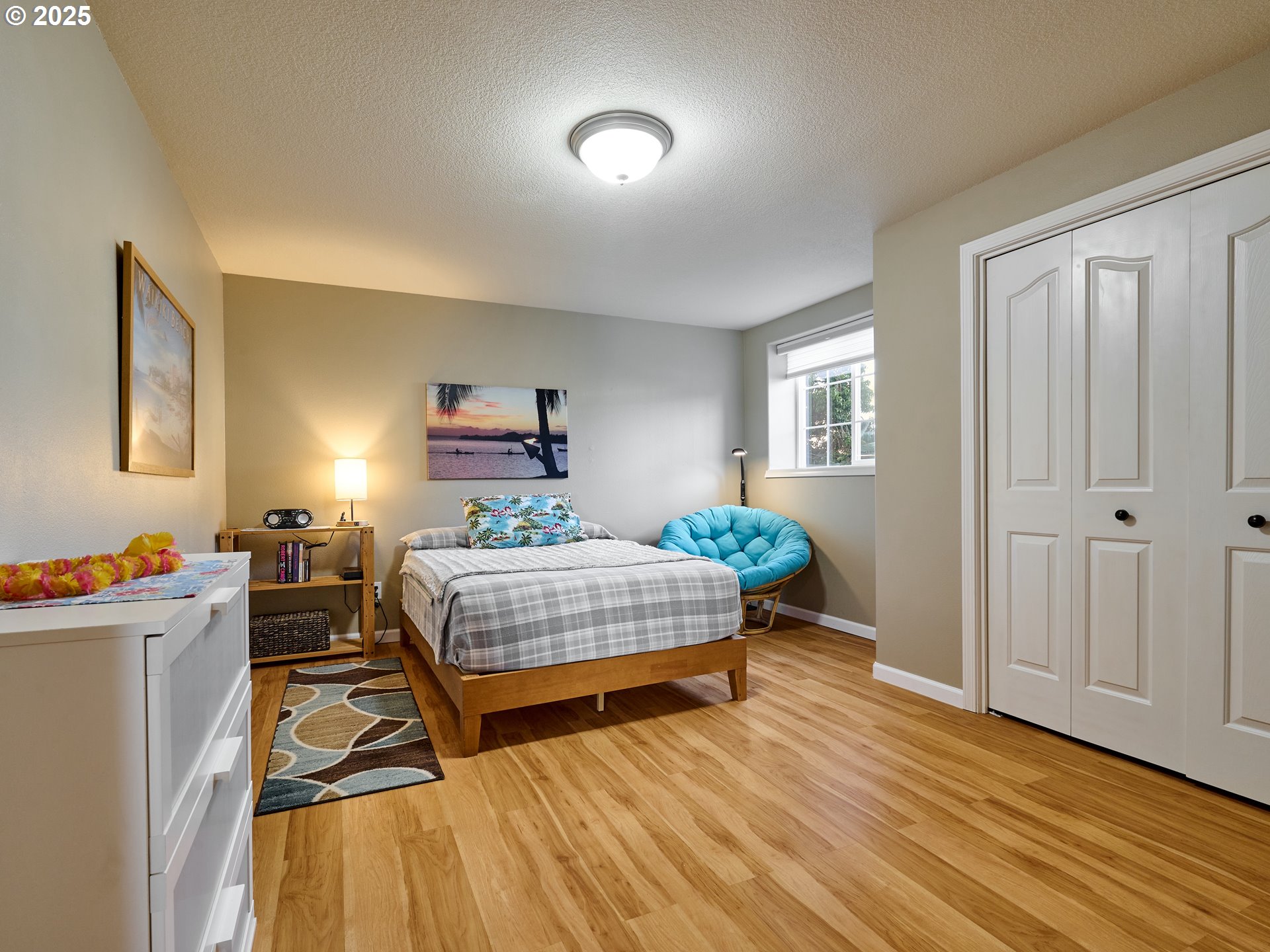 920 Hermanson Street Woodburn, OR 97071 - Photo 24 of 48 a bedroom with a bed and wooden floor