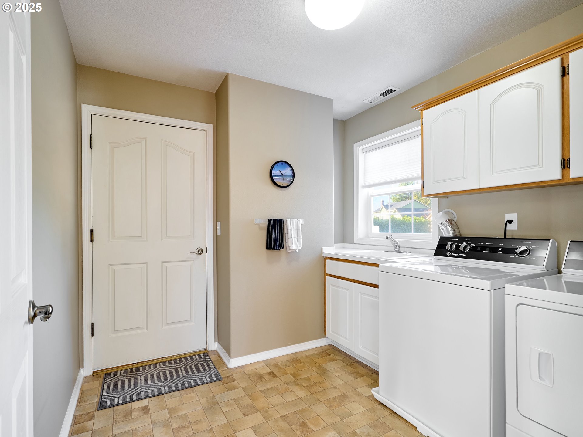 920 Hermanson Street Woodburn, OR 97071 - Photo 27 of 48 a kitchen with a stove a sink and a window