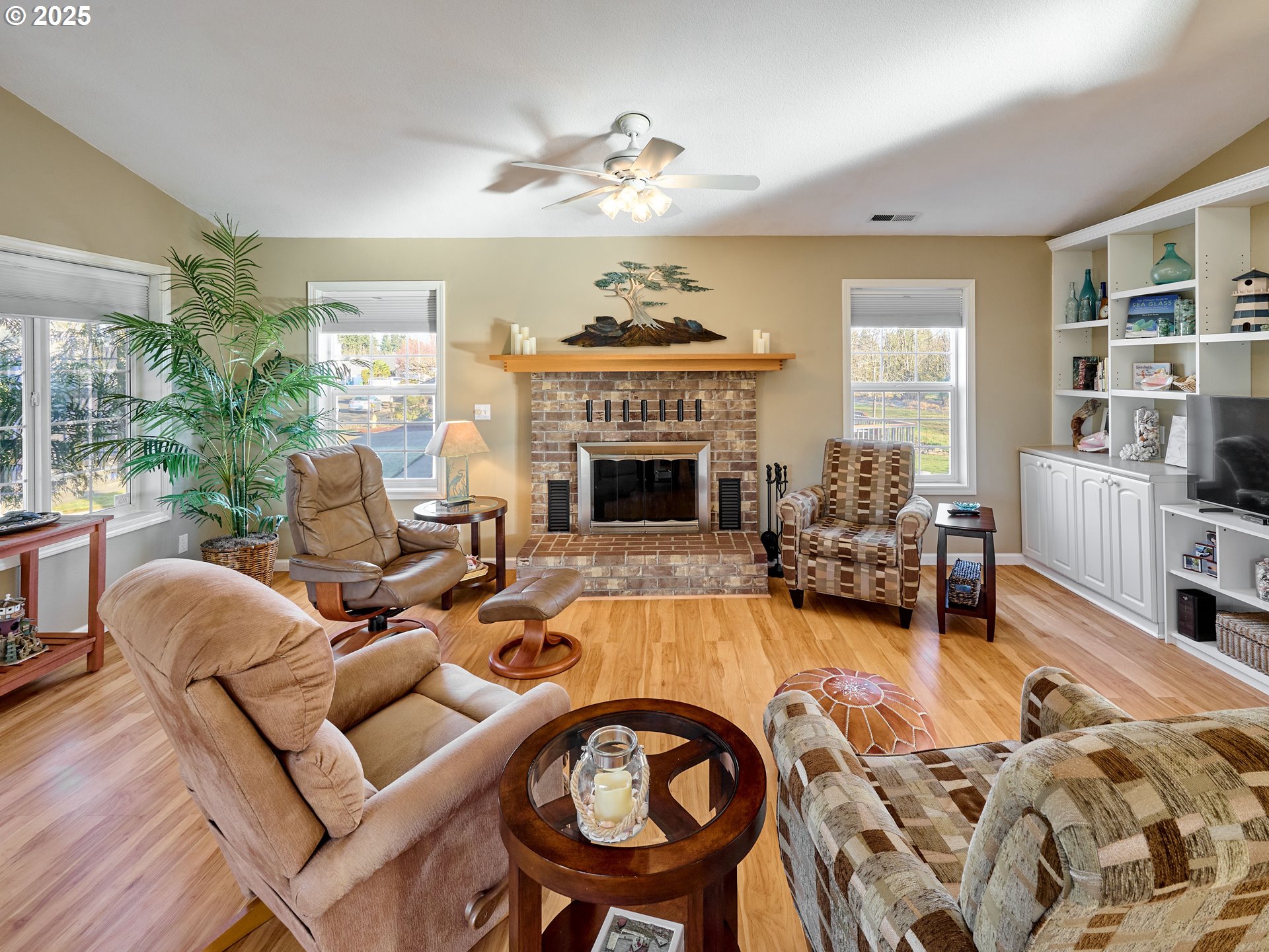 920 Hermanson Street Woodburn, OR 97071 - Photo 5 of 48 a living room with furniture a fireplace and a chandelier