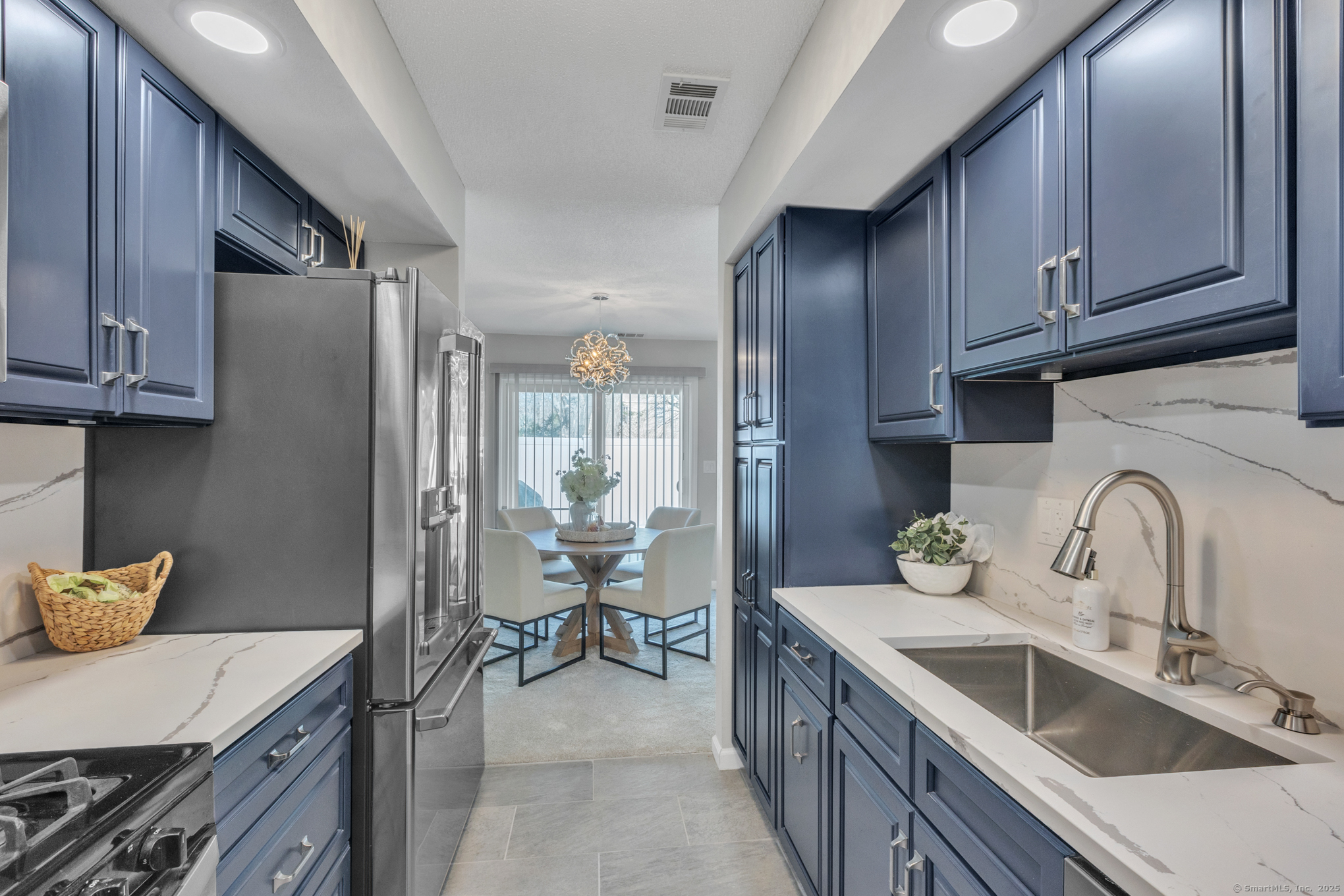 16 Maple Street, Unit 11 Vernon, CT 06066 - Photo 12 of 29 a kitchen with stainless steel appliances granite countertop a sink stove and cabinets