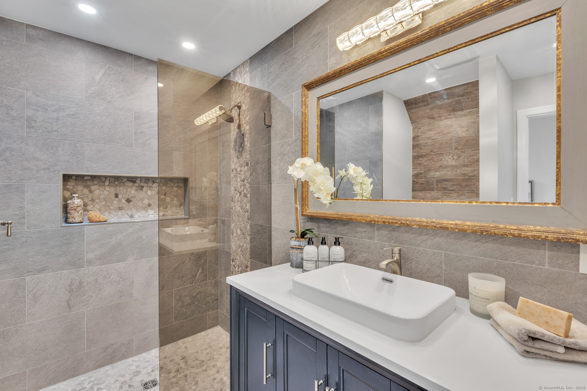 16 Maple Street, Unit 11 Vernon, CT 06066 - Photo 19 of 29 a bathroom with a sink a large mirror and a shower