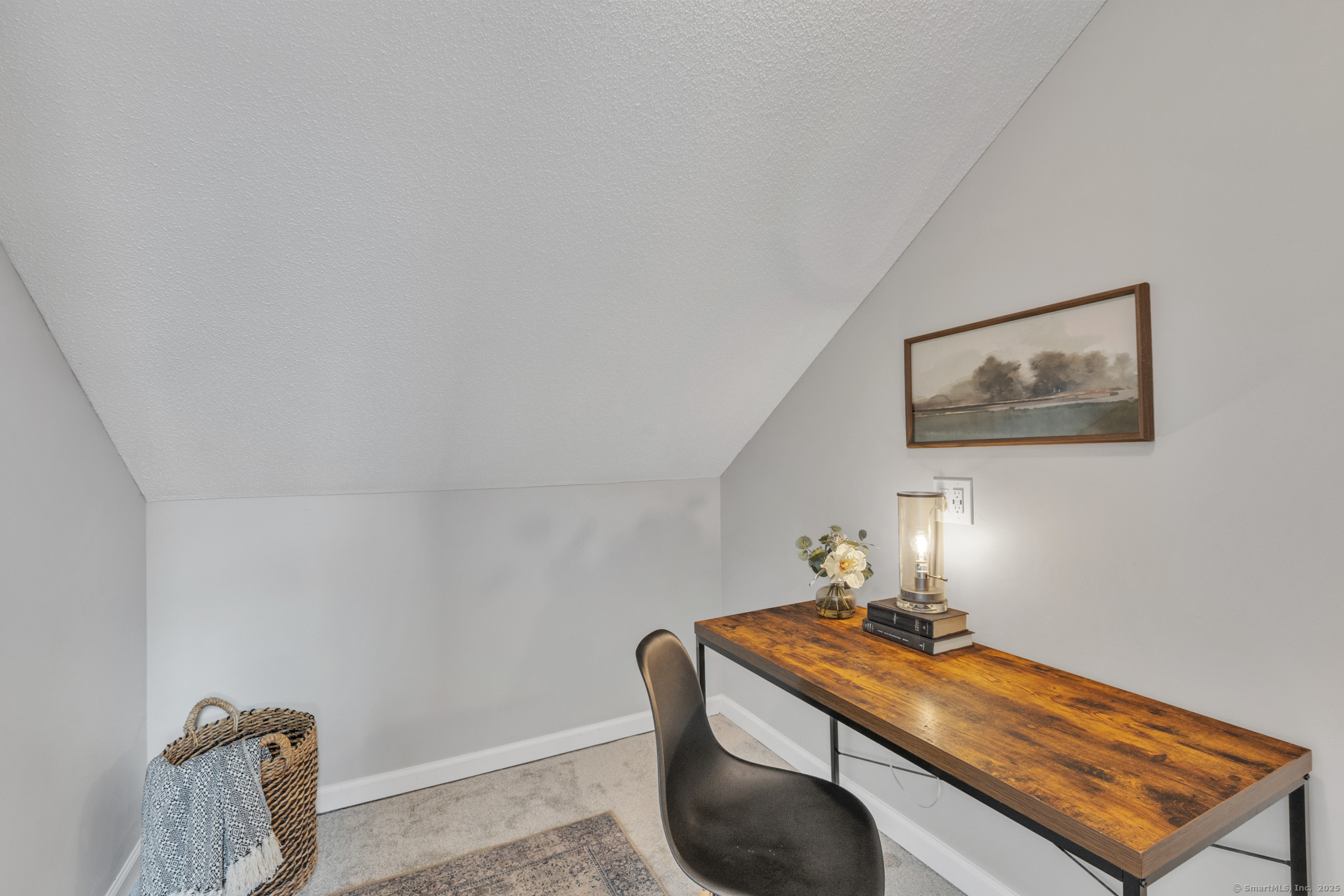 16 Maple Street, Unit 11 Vernon, CT 06066 - Photo 22 of 29 a room with a desk and flowerpot