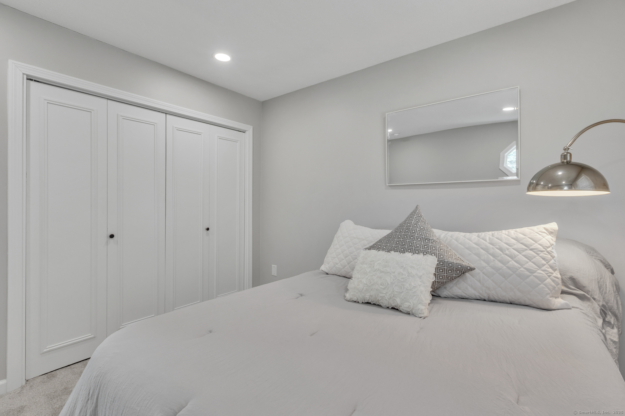 16 Maple Street, Unit 11 Vernon, CT 06066 - Photo 23 of 29 a large bed sitting in a bedroom next to a cabinet