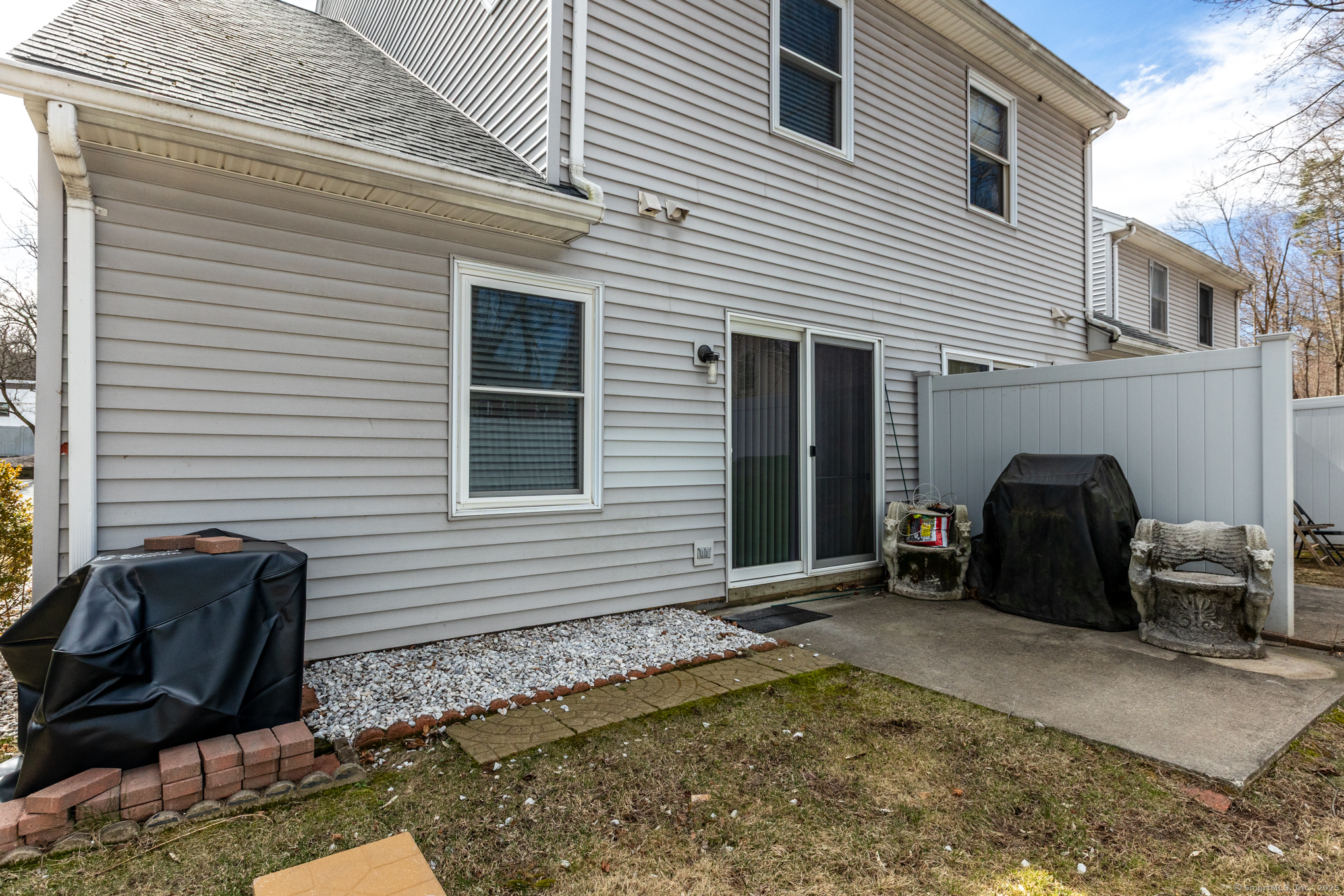 16 Maple Street, Unit 11 Vernon, CT 06066 - Photo 28 of 29 a view of a house with a barbeque and wooden chair