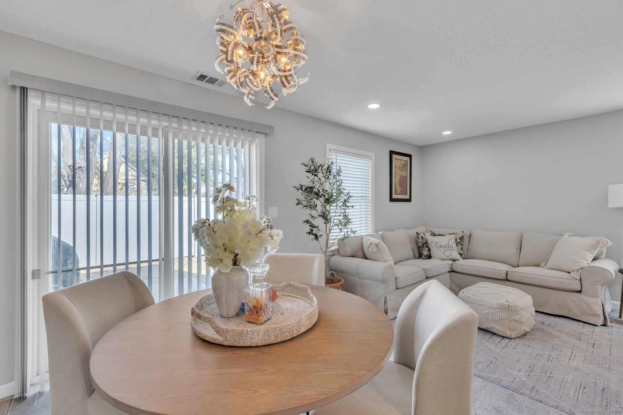 16 Maple Street, Unit 11 Vernon, CT 06066 - Photo 7 of 29 a living room with furniture and a chandelier