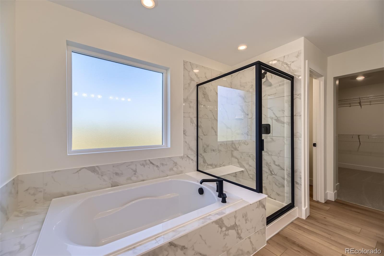 42984 Colonial Trail Elizabeth, CO 80107 - Photo 17 of 31 a bathroom with a bathtub and a shower