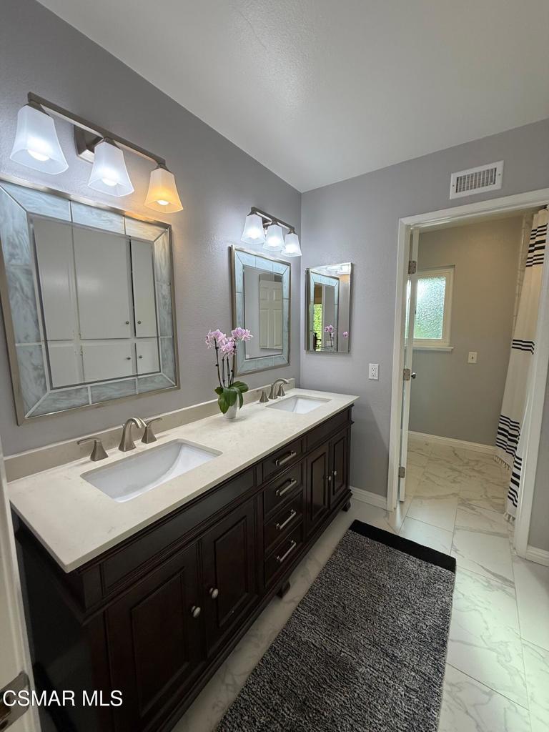 259 Sinaloa Road Simi Valley, CA 93065 - Photo 13 of 17 a bathroom with a sink and a mirror