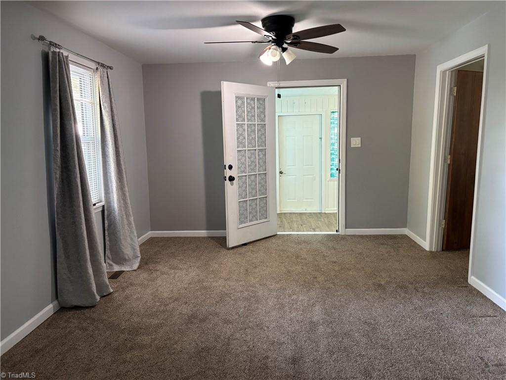 2327 Scalesville Road Summerfield, NC 27358 - Photo 6 of 28 THE LIVING ROOM , THE DOOR TO YOUR RIGHT IS A BEDROOM AND THE OPEN DOOR GOES TO THEDINING ROOM OR SUNROOM