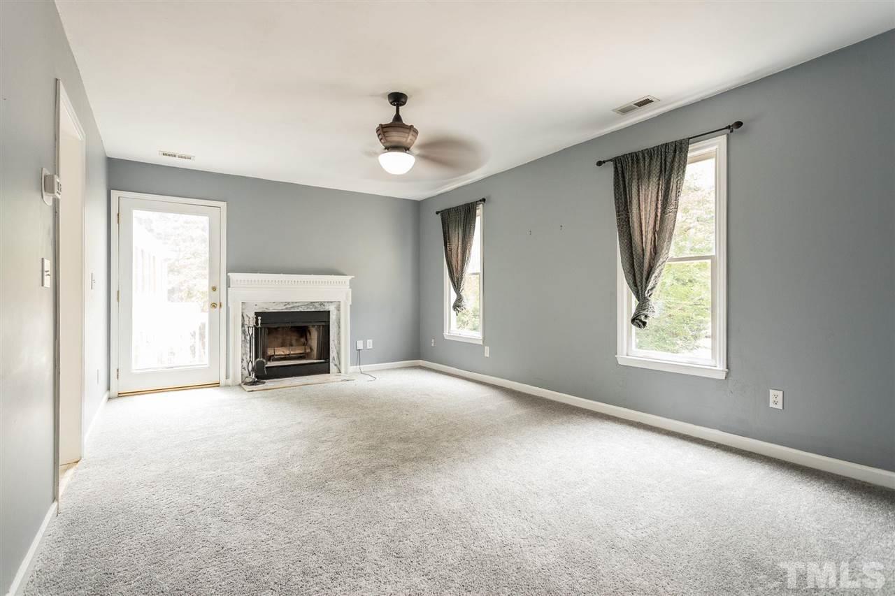 4116 Iron Horse Road Raleigh, NC 27616 - Photo 11 of 29 an empty room with windows fireplace and fan