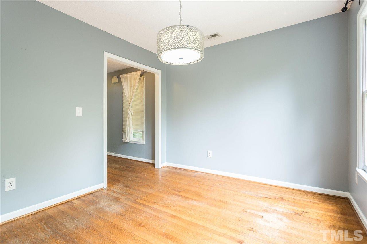 4116 Iron Horse Road Raleigh, NC 27616 - Photo 18 of 29 an empty room with a chandelier fan and windows