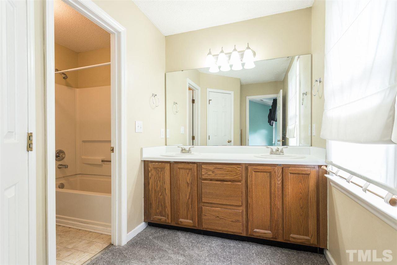 4116 Iron Horse Road Raleigh, NC 27616 - Photo 24 of 29 a spacious bathroom with a double vanity sink and a mirror
