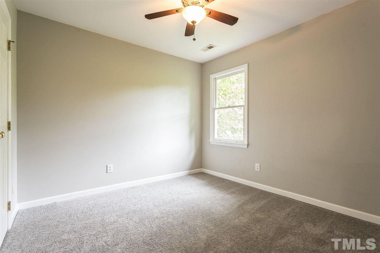 4116 Iron Horse Road Raleigh, NC 27616 - Photo 27 of 29 an empty room with a window and a chandelier fan