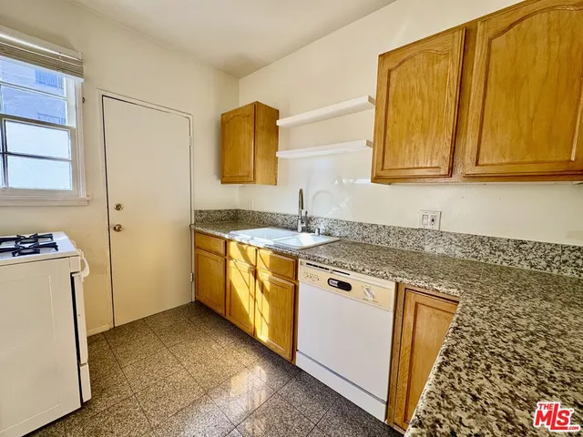 a kitchen with a sink stove and refrigerator