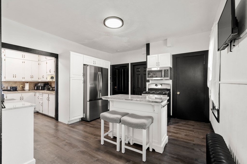 723 Main Street Southbridge, MA 01550 - Photo 23 of 41 a kitchen with a refrigerator and a stove top oven