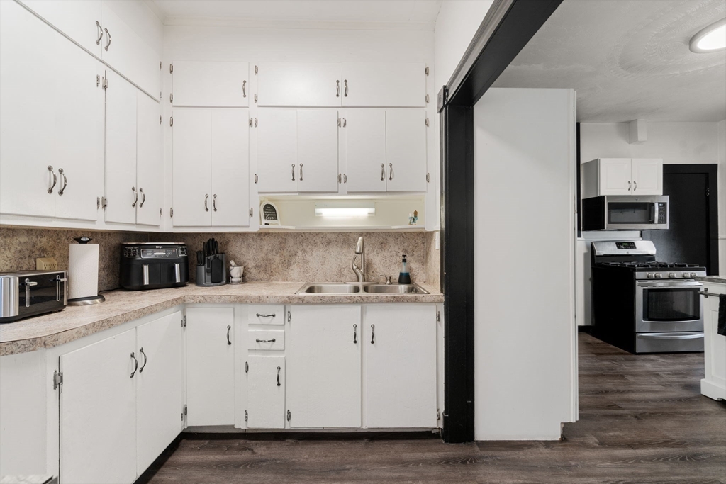 723 Main Street Southbridge, MA 01550 - Photo 28 of 41 a kitchen with stainless steel appliances granite countertop a sink a stove and a refrigerator