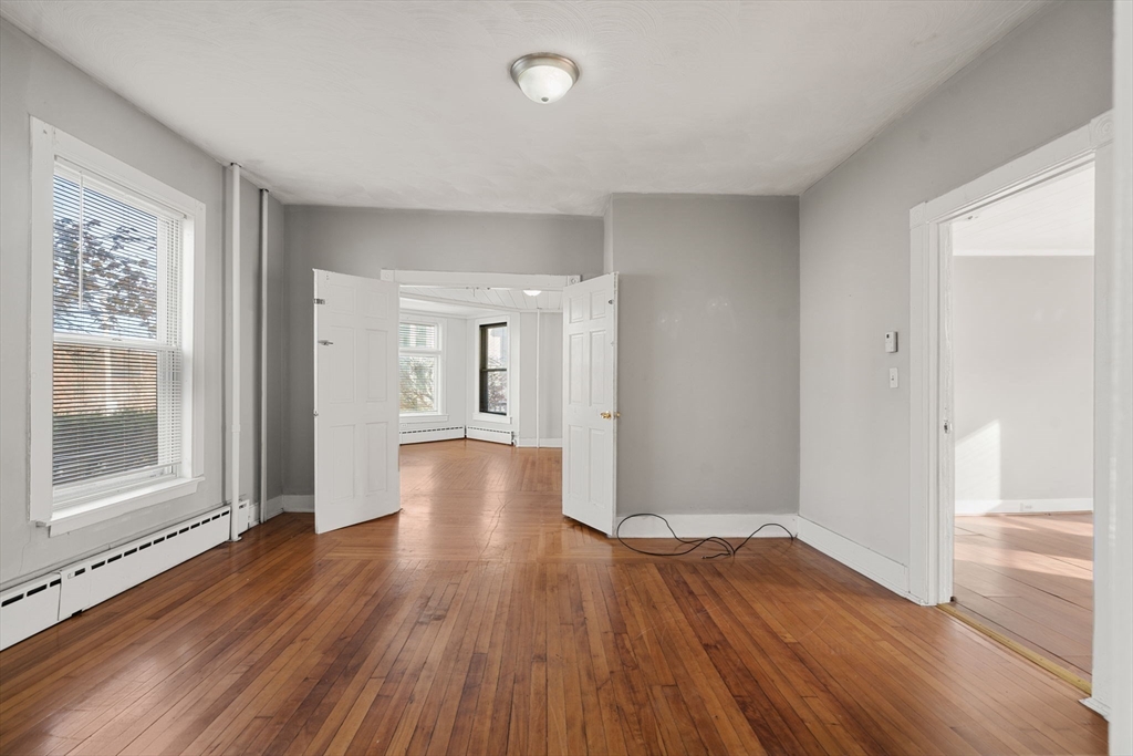 723 Main Street Southbridge, MA 01550 - Photo 4 of 41 wooden floor in an empty room with a window