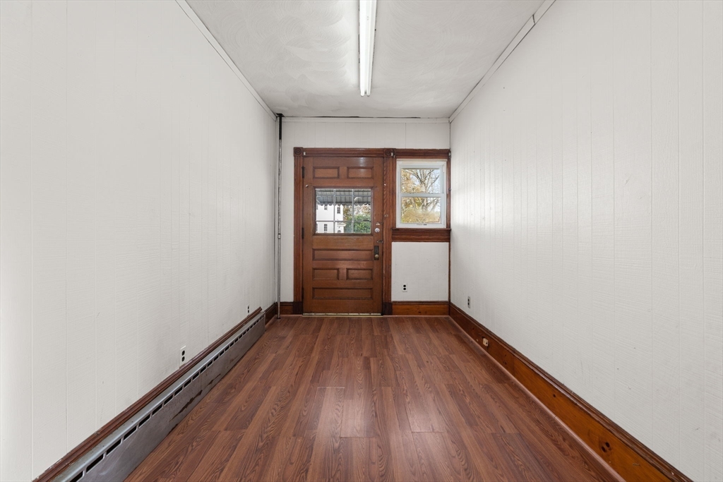 723 Main Street Southbridge, MA 01550 - Photo 8 of 41 an empty room with wooden floor cabinet and windows
