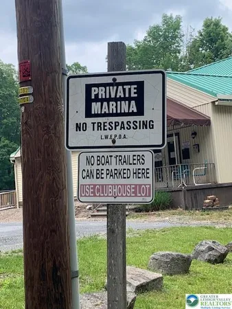 a view of swimming pool with lawn chairs and plants